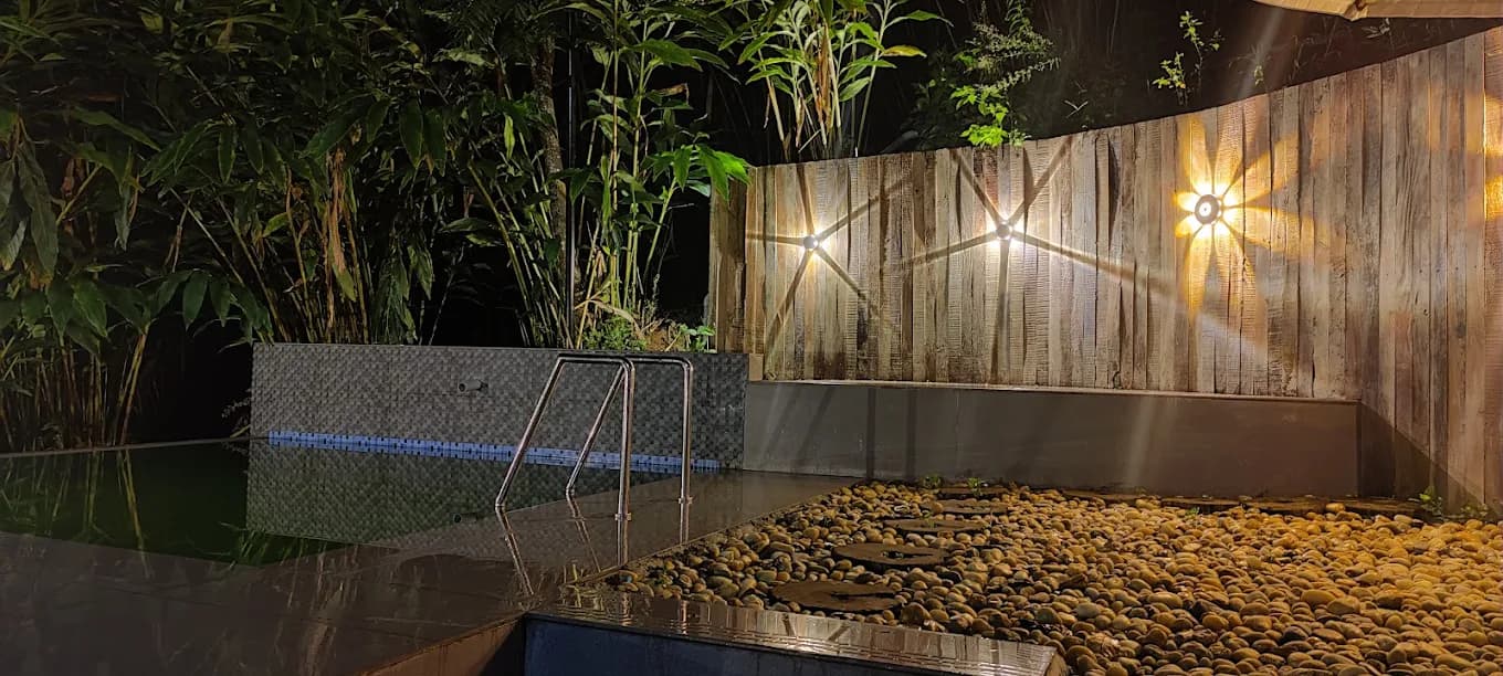 The pool lit up in the evening at Gramina Resort, Vagamon